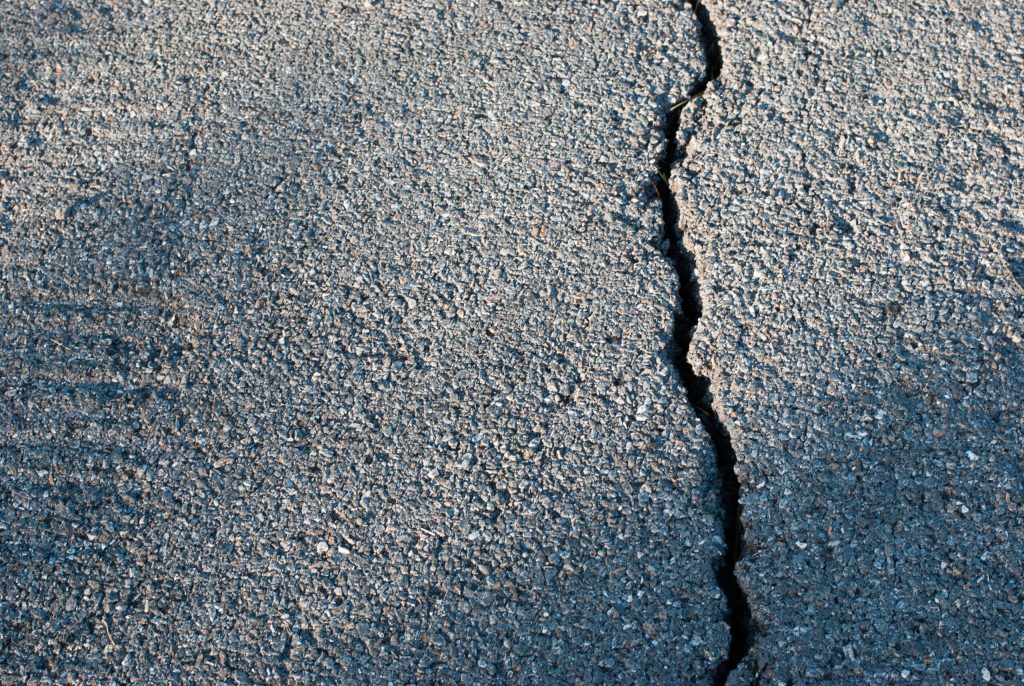 Cracked asphalt road during extreme heatwave